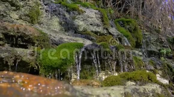 在瀑布景观上旅行美丽的瀑布自然淡水流经长满苔藓的石头视频的预览图