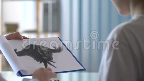 精神病医生向病人展示绘画和书写诊断能力测试视频的预览图