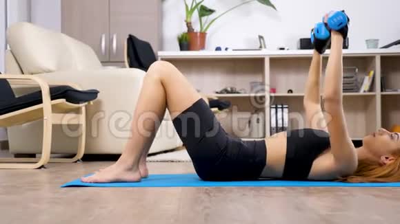 年轻的阿拉伯混血女人躺在一张蓝色垫子上练习运动视频的预览图