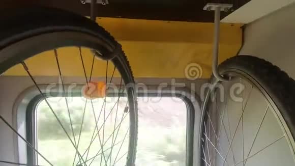 自行车挂在火车的架子上绿树挂在窗户上视频的预览图