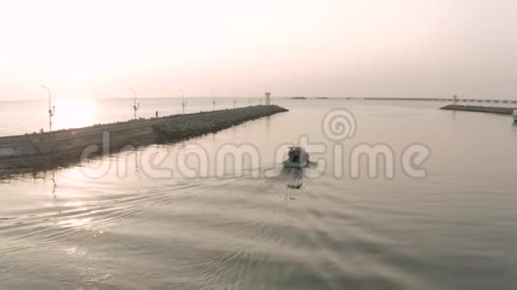 亚洲渔船和海上码头灯塔日落时间视频的预览图