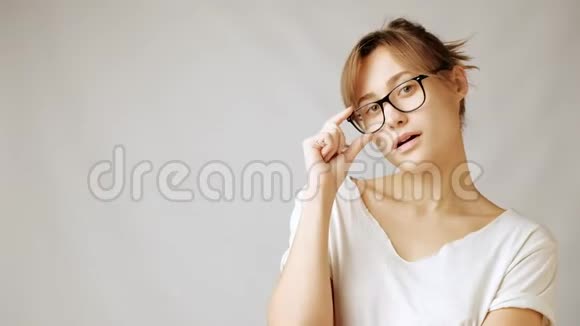 戴眼镜的年轻纽德妇女紧张地拿着笔想着什么视频的预览图