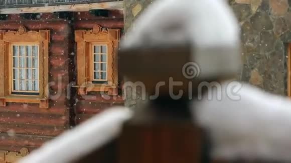 在大雪纷飞期间可以近距离观看带有经典窗户的山村小屋带有俄罗斯风格的雕刻木制视频的预览图