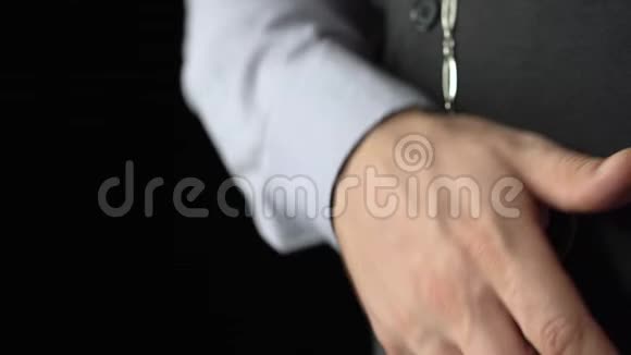 钟表匠拿出一只古董手表放在链子上放在她的手掌里黑色背景声音视频的预览图