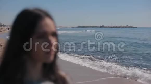 在美丽的海洋和海滩背景下一个女孩的近距离视野女孩戴上墨镜视频的预览图