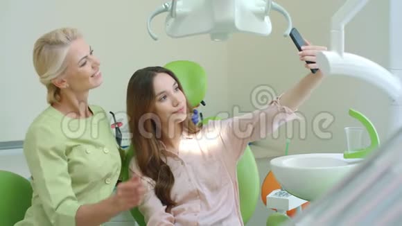 快乐医生和病人一起自拍戴牙椅的微笑女人视频的预览图