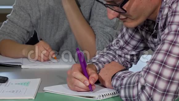 年轻人在学习时写课本视频的预览图