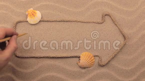 牙买加手写在沙子上的铭文用绳子做成的指针视频的预览图