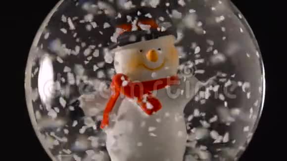 冬天的雪球里面有黑色背景的雪人视频的预览图
