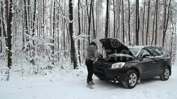 汽车在森林里的一条雪道上抛锚了视频的预览图