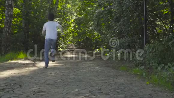 一个男孩穿过公园的小巷视频的预览图