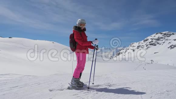 白人女子滑雪者站在滑雪场的斜坡上的肖像微笑视频的预览图