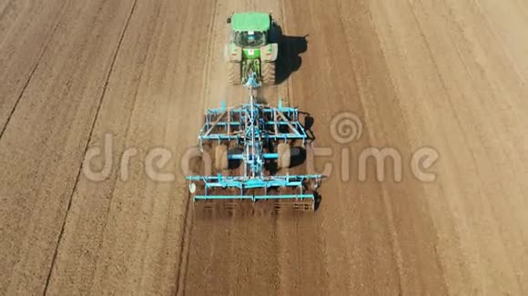 拖拉机和圆盘耙在农田上拖拉机在犁地上俯视农业种植领域视频的预览图