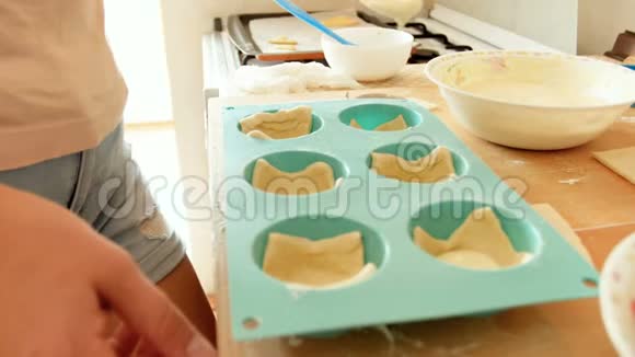 特写4k镜头年轻家庭主妇用甜馅填充硅胶烘焙表格视频的预览图