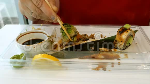 女人用木筷和芥末吃寿司视频的预览图