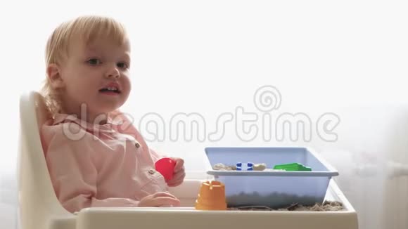 一岁的女孩可爱的女婴的手玩机智的女婴吃汤孩子学会自己用勺子吃饭视频的预览图