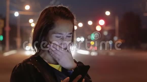 兴奋年轻的女孩打电话在夜城哭泣视频的预览图