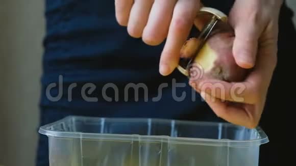 女厨师用切菜机在塑料容器上切土豆皮视频的预览图