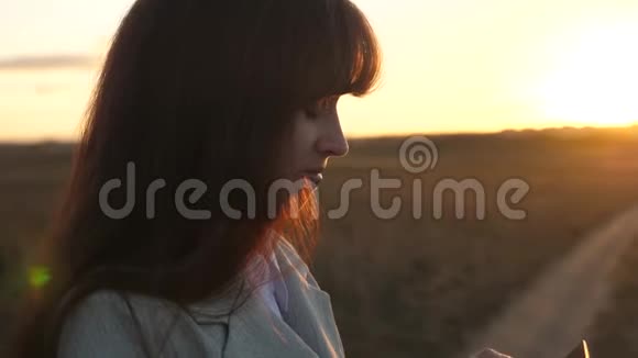 美丽的商务女性触摸智能手机屏幕与手指的日落一个女农民用平板电脑工作视频的预览图