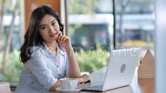美丽的亚洲年轻微笑的女休闲女商人或自由职业者学生的肖像视频的预览图