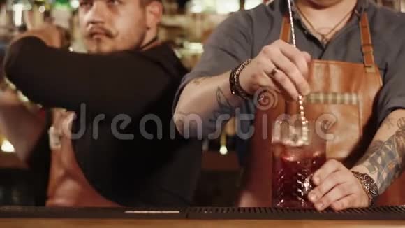 酒吧里的同伴们在酒吧里准备酒精鸡尾酒视频的预览图