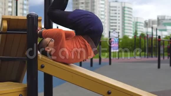 一个年轻人正在长凳上摇着一个压力机视频的预览图