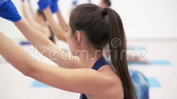 年轻的运动女孩在蓝色健身吊床上伸展视频的预览图