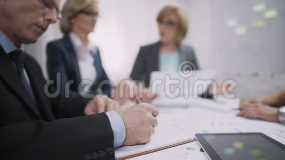 销售经理在头脑风暴会议上写在笔记本上工作过程视频的预览图