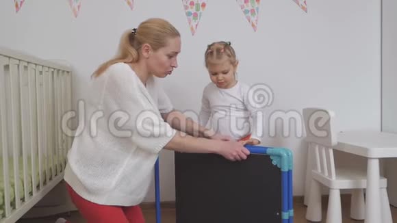 一个女人给她的小女儿看画板孩子得到了快乐的礼物视频的预览图