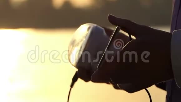 日落时手电筒和太阳电池在男性手中视频的预览图