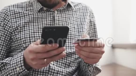 男人用智能手机和信用卡上的应用在网上转账视频的预览图