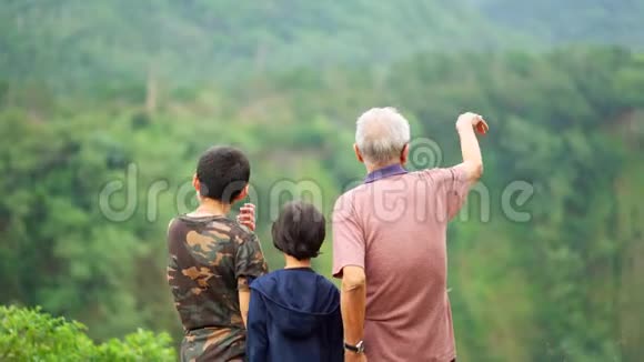 爷爷和孙子们站在公园里视频的预览图