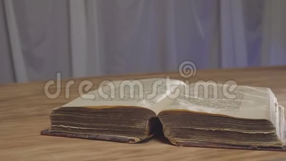 打开的旧书在桌上视频的预览图