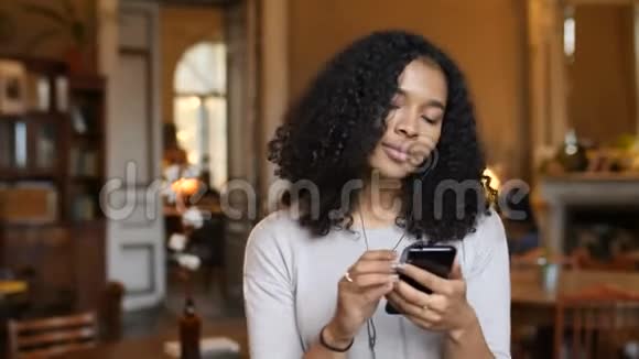 年轻的非裔美国黑人妇女听电话音乐在4k咖啡馆跳舞视频的预览图