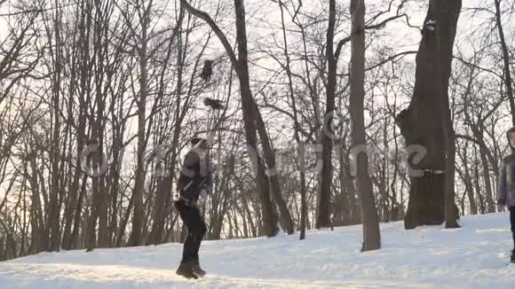 小男孩把手套扔在冬天公园的雪地上视频的预览图