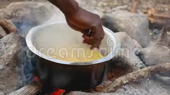 用汤匙将意大利面食放入火盆中特写非裔美国人的手视频的预览图