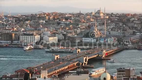 日落时欣赏加拉塔大桥和清真寺许多海鸥在飞翔旅游船在漂浮伊斯坦布尔视频的预览图