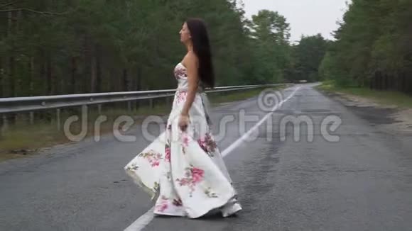 一个穿着长裙的漂亮女孩正在路上旋转视频的预览图