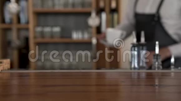 一位咖啡师把一杯新鲜的热咖啡送到柜台视频的预览图