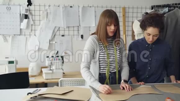 创意设计师团队正在裁缝店里处理服装图案和面料年轻妇女集中在视频的预览图