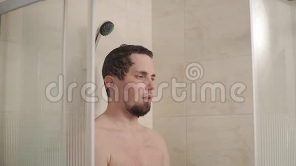 站在浴室淋浴下看风景的人的肖像视频的预览图