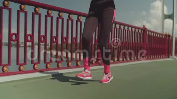 健康女运动员沿着城市大桥奔跑视频的预览图