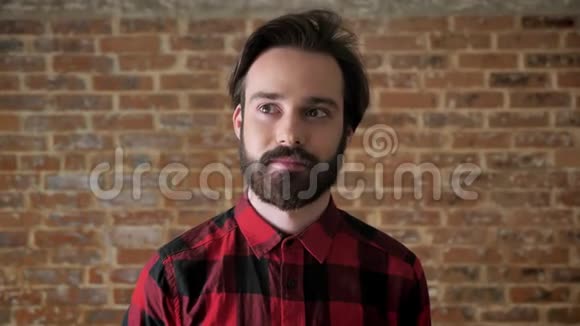 年轻的有胡子的帅哥正在创造创意微笑思考过程砖背景视频的预览图