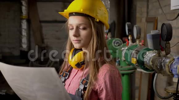 年轻认真的女建筑工人正在看建筑计划看上面思考视频的预览图