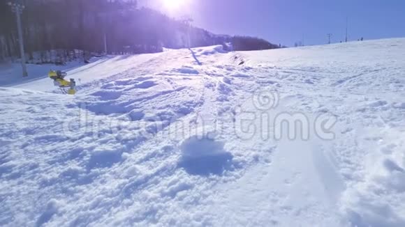 黄色动作年轻的职业滑雪者骑着半管在大山雪地公园在半管上喷洒雪到照相机里视频的预览图