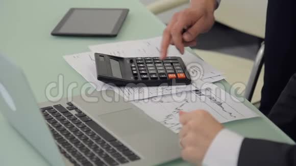 商务人士的特写都在依靠桌面上的计算器视频的预览图