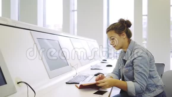 在电脑附近学习的年轻女子视频的预览图