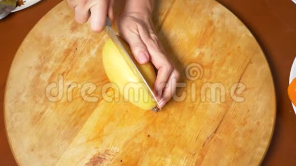 餐桌上的异国水果女人手在切割板上准备芒果视频的预览图