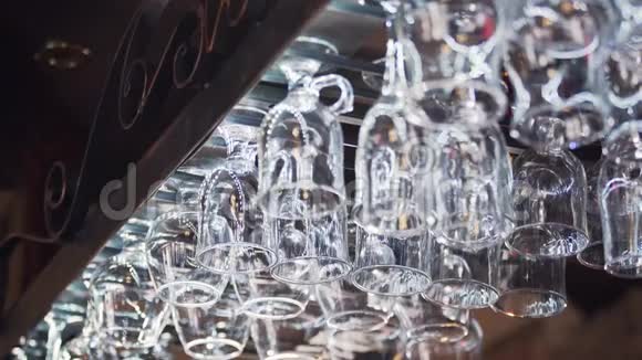 不同的眼镜挂在酒吧柜台上方的玻璃器皿支架上视频的预览图