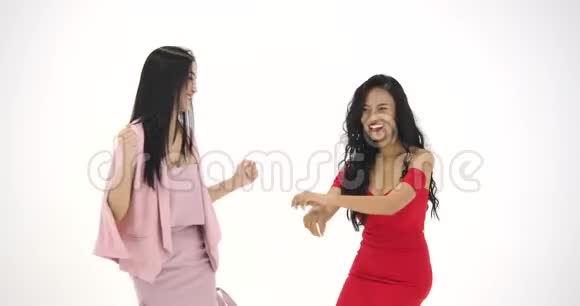 两个亚洲女人在白色背景下疯狂跳舞派对庆祝享受新的人视频的预览图